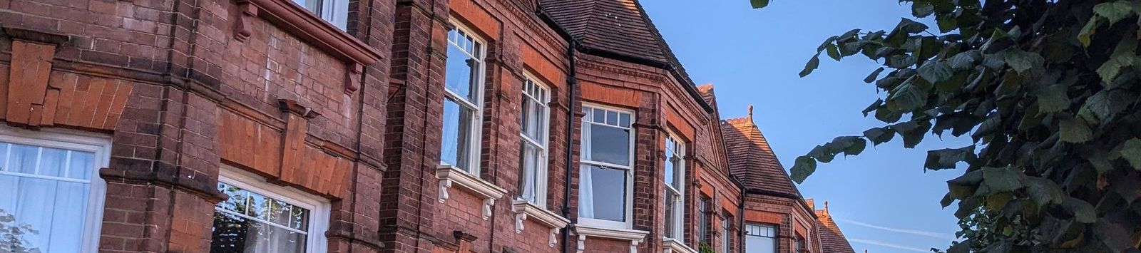 A row of Victorian terraced houses on a residential street